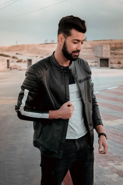 a man in a leather jacket on the street