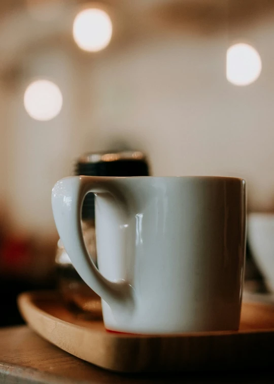 three empty coffee cups on a wooden tray