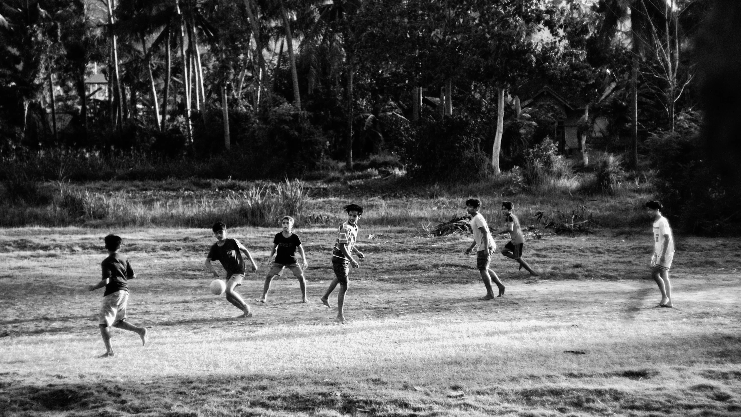 black and white pograph of people running on a grassy field