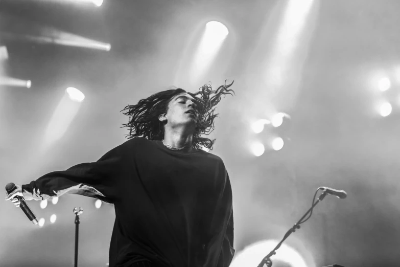 a person with dreads holding his arms out