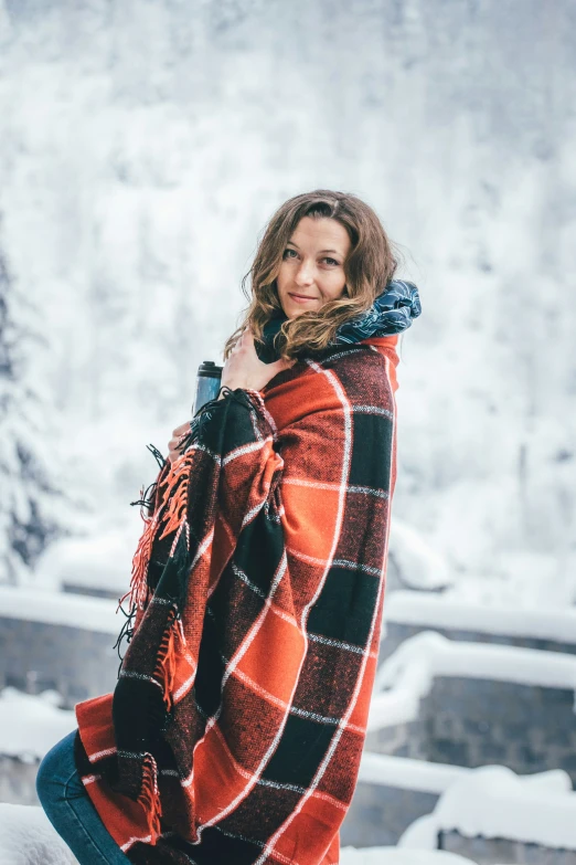 the woman is posing by herself in the snow