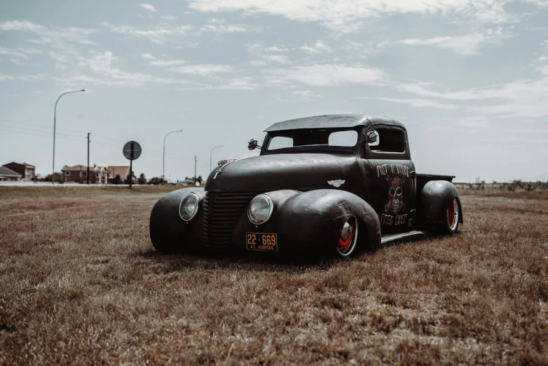 a truck is parked in the field on a cloudy day