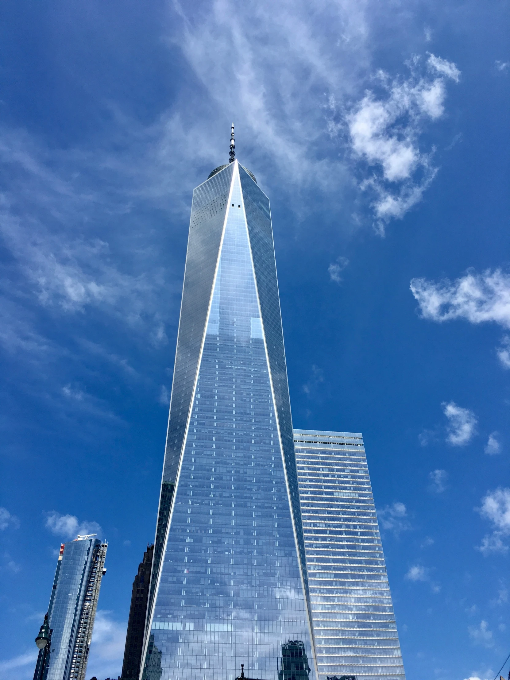 a skyscr building with clouds over it