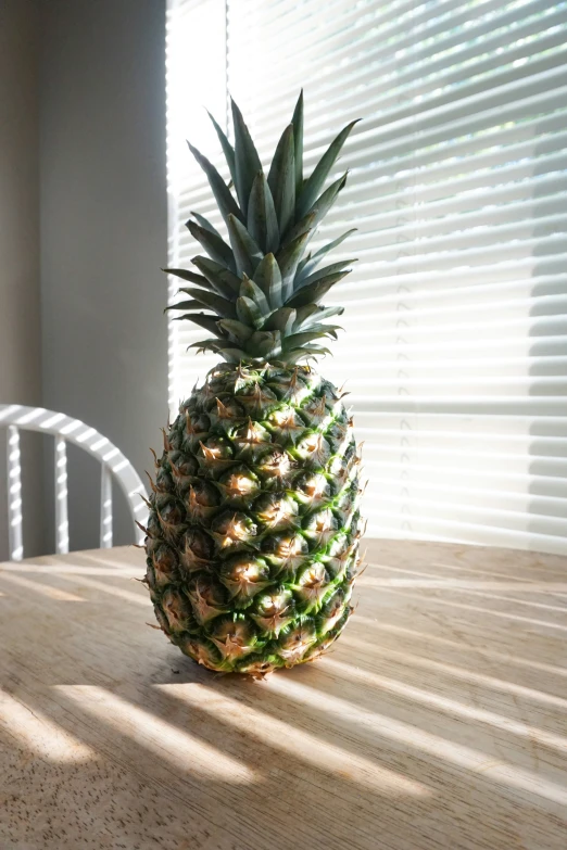 a pineapple sitting on top of a wooden table