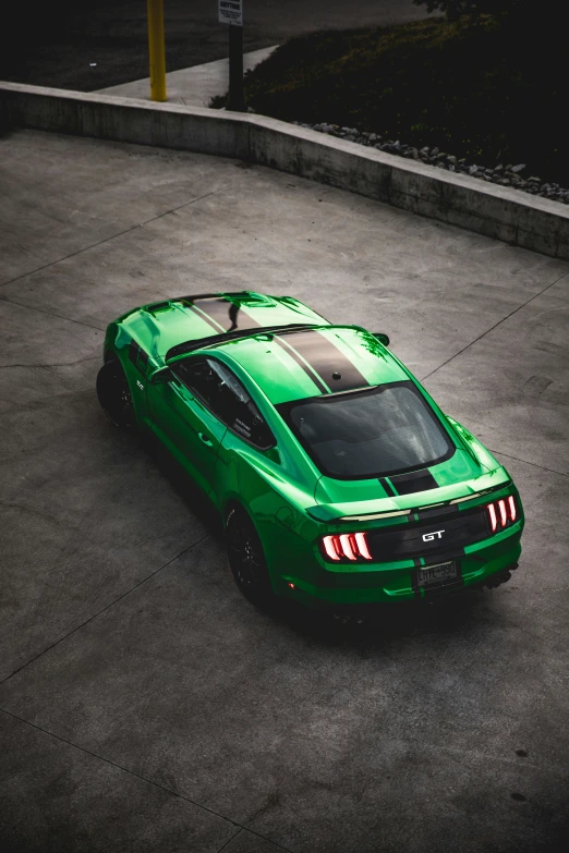 a green car parked in a parking lot