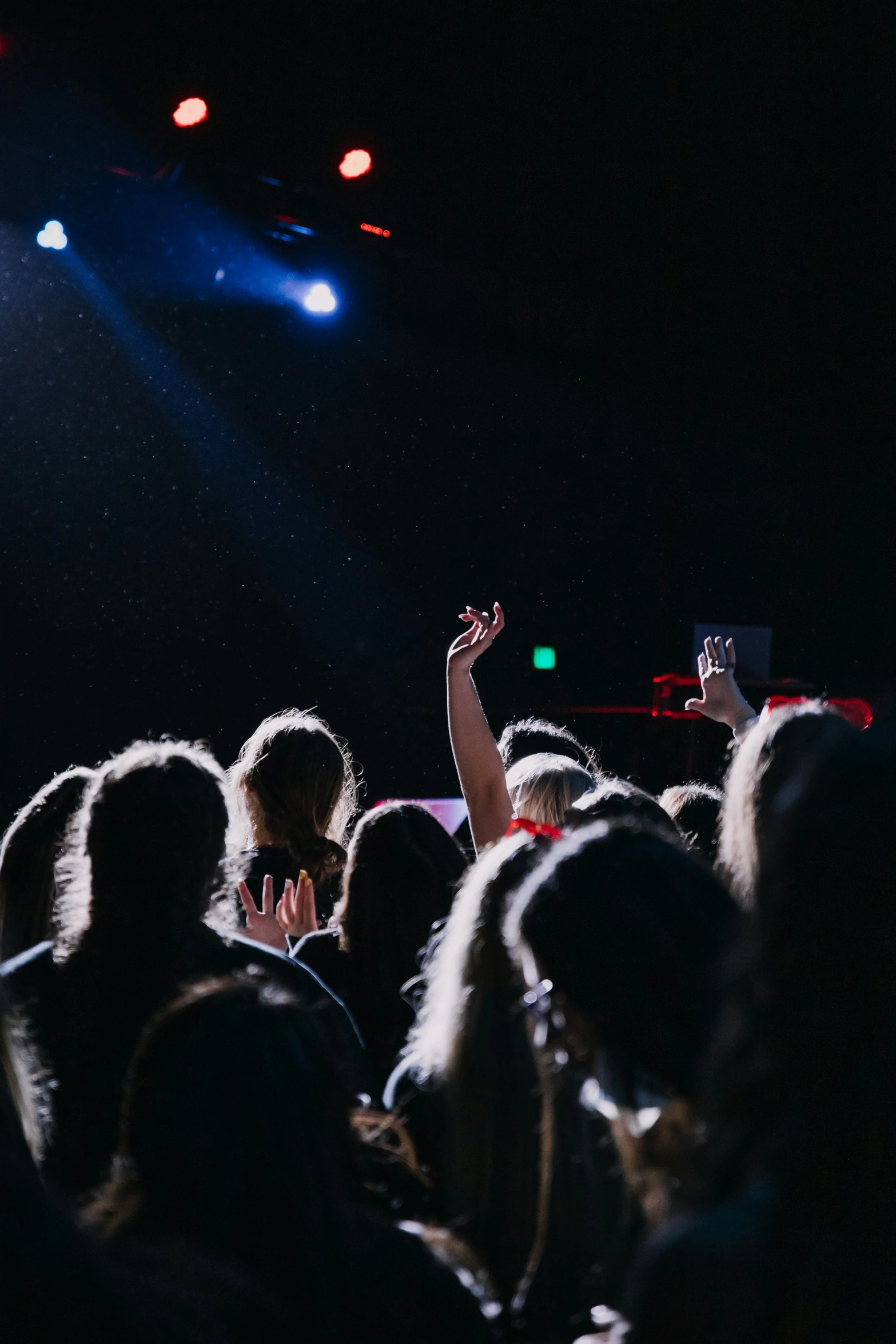 a man performing on stage surrounded by people