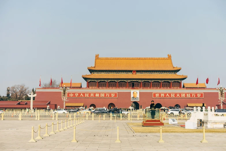 a large building with many flags near it