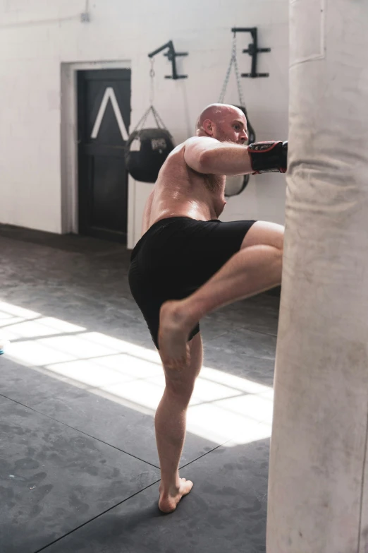 a shirtless man in black is in the ring