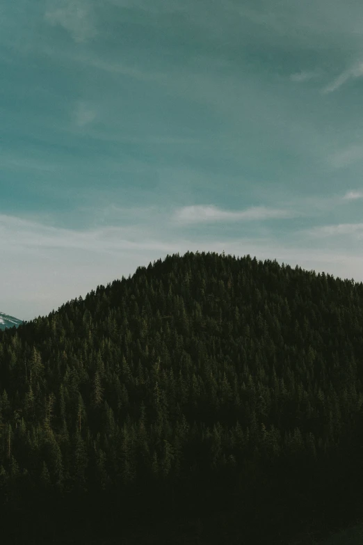 the hill is silhouetted against the sky and with an arrow pointing up