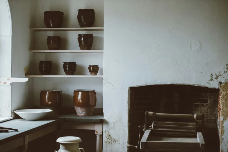 a view of a stove, shelves, and oven in an abandoned kitchen