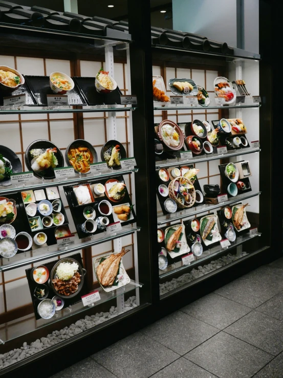 a display case in a building with sushi dishes