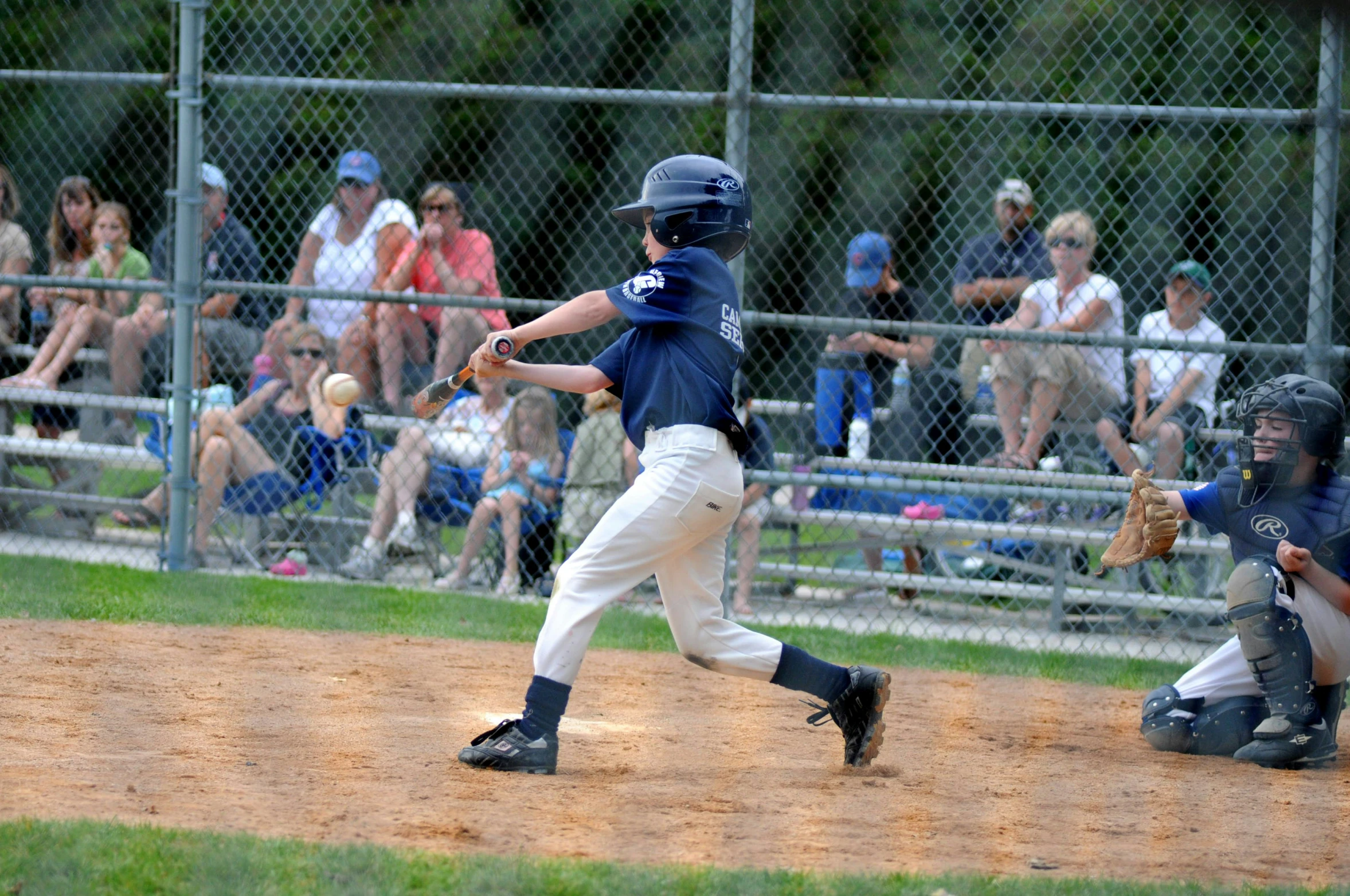 a boy at bat during a baseball game