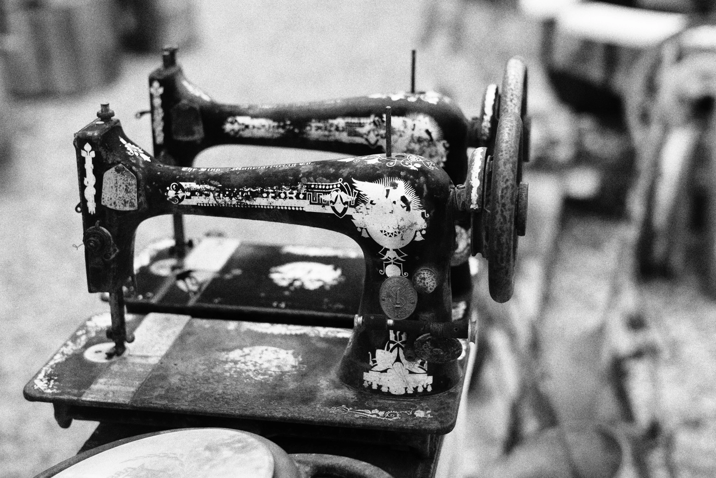 old black and white po of an antique sewing machine