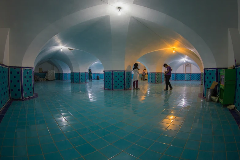 a bathroom area with tiles and blue colored walls