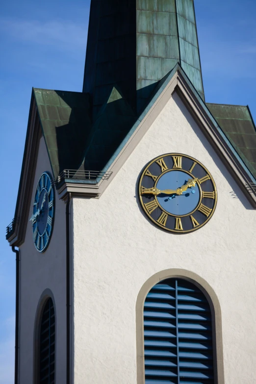 a large clock is on top of the steeple