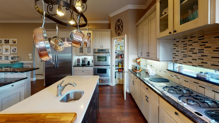 a kitchen with a stainless steel stove top and refrigerator