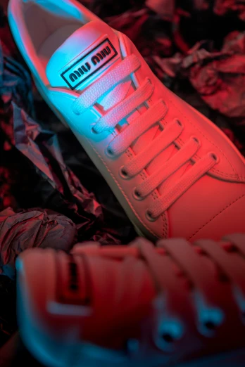 an illuminated shoe is next to the red shoes