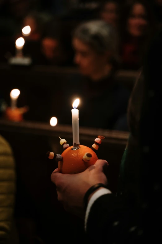 candle lit in an orange shaped like an elephant