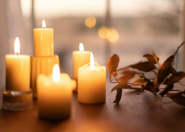 a couple of candles sitting on top of a table