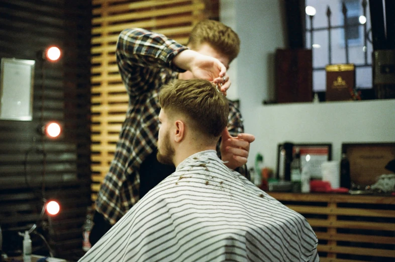 a man getting ready to cut another mans hair