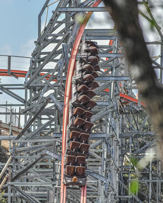 a roller coaster with many cars at an amut park