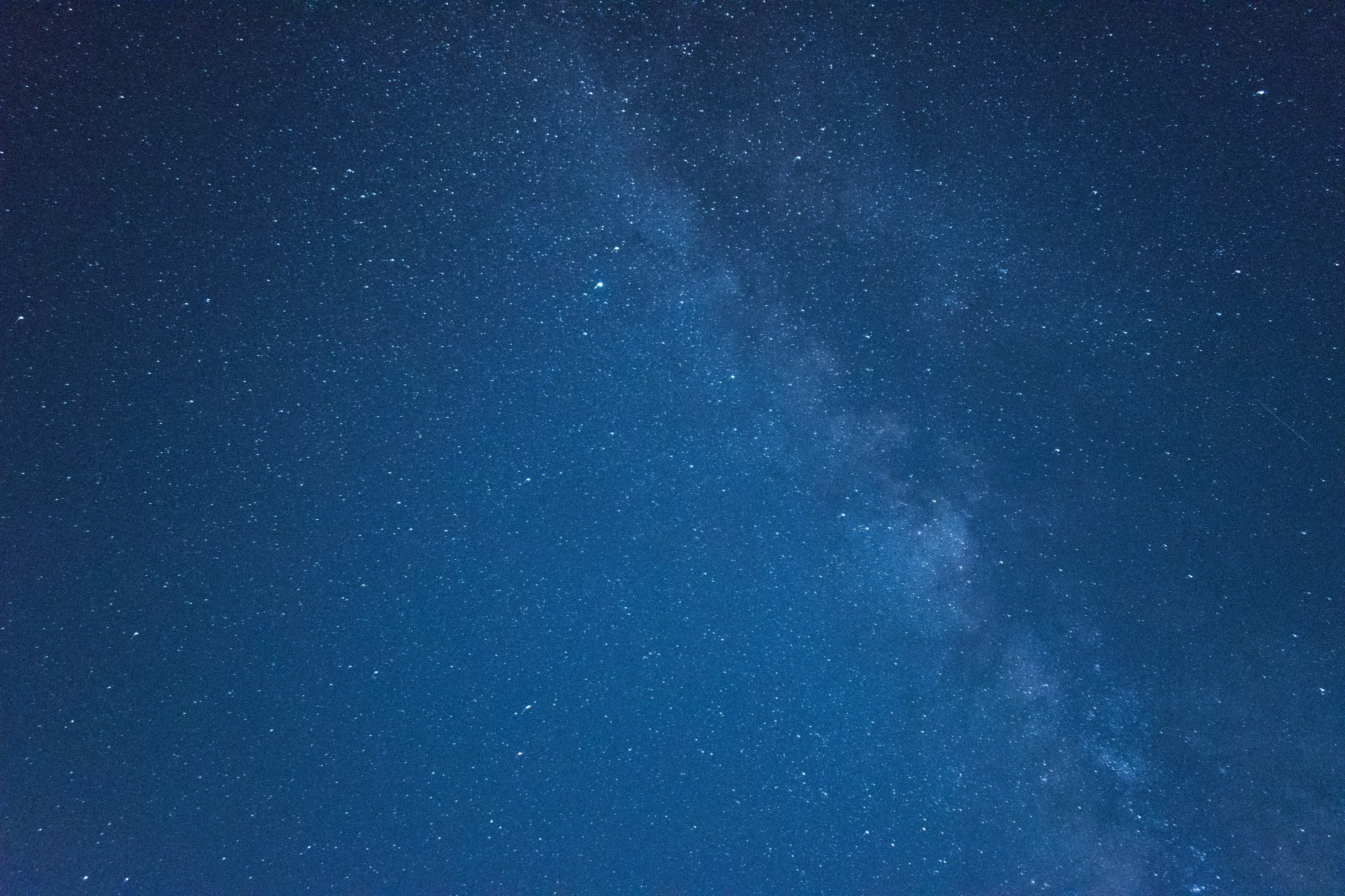 the night sky shows a pattern over a small lake