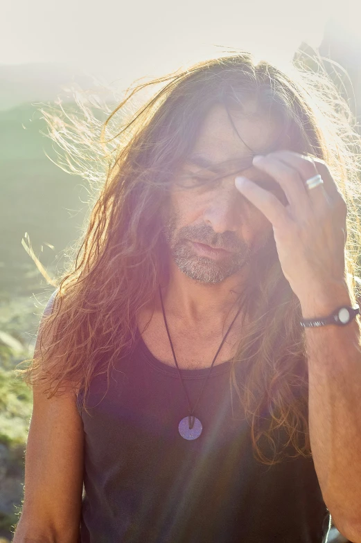 a man with long hair looking at the camera