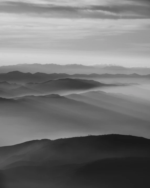 hazy view of mountains from top of a hill