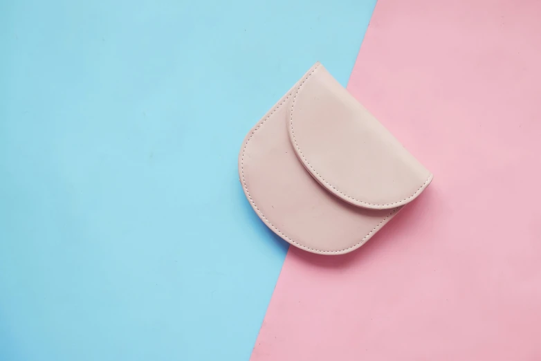 a piece of pink leather on blue and pink background