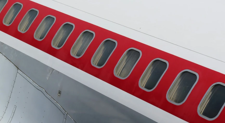 an airplane has red trim along it's wing