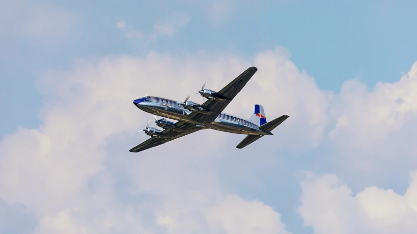 two blue and white planes flying in the sky