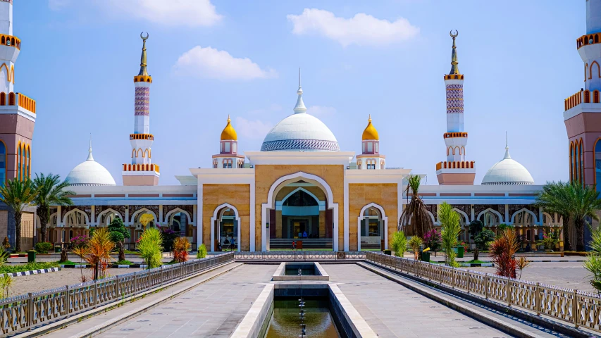 a large outdoor building with a fountain and a clock