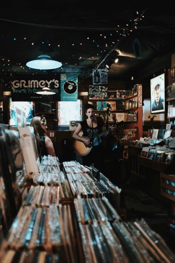 a woman is playing guitar inside a store