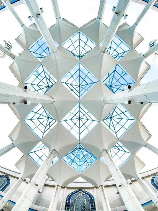 the ceiling in a building has several blue and white walls