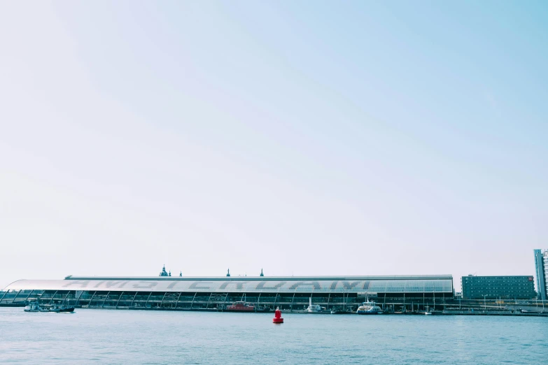 a body of water next to a pier on a city street