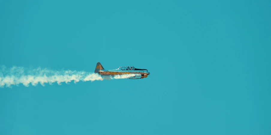 an airplane is flying through the blue sky