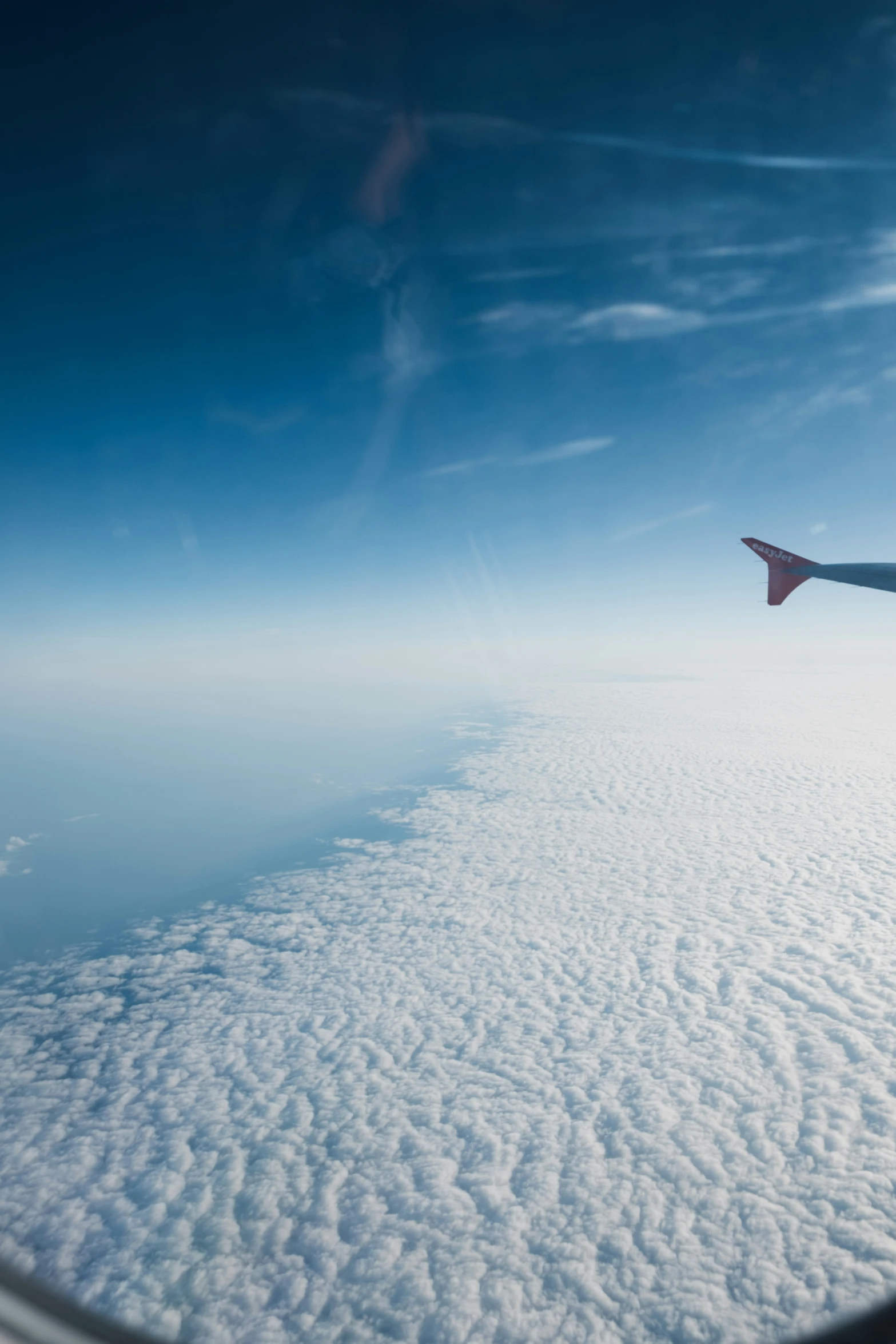 the view from inside an airplane looking down at the clouds below