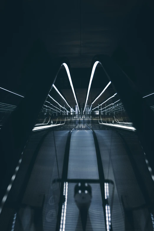 an escalator in a subway system at night