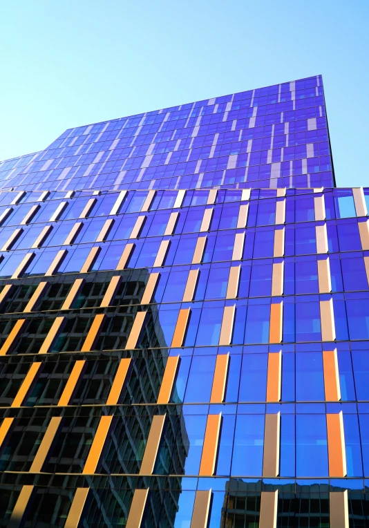 a high rise building with orange stripes on the outside