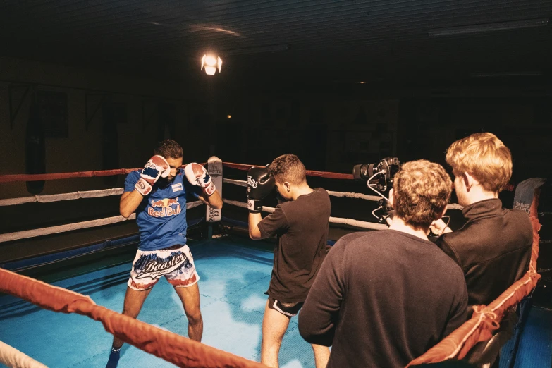 a group of boys playing boxing in the ring