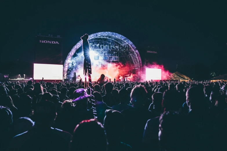 a large crowd watching a band on stage