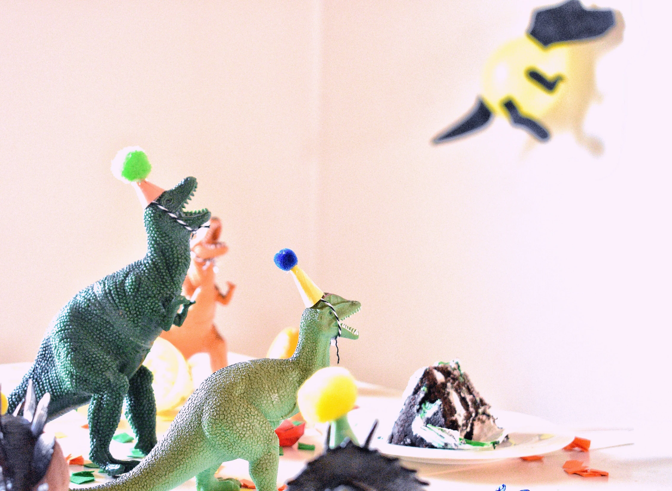 toys are arranged on a table with dinosaurs