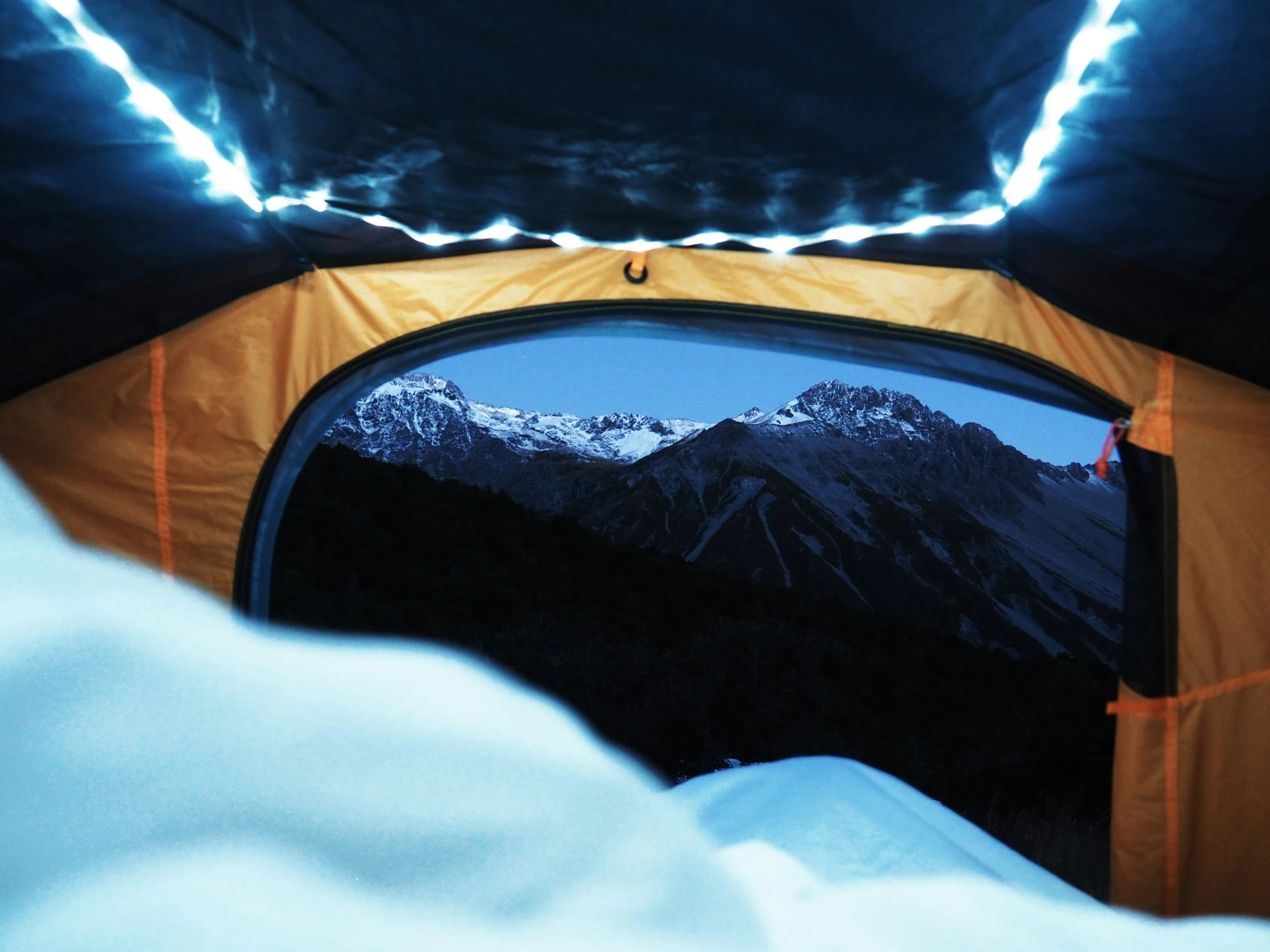 the inside of an illuminated tent is seen