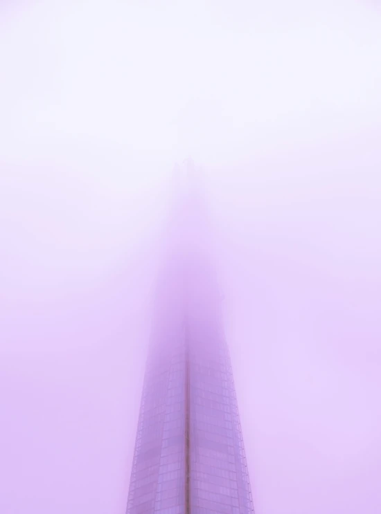 pink fog is covering a large skyscr near its entrance