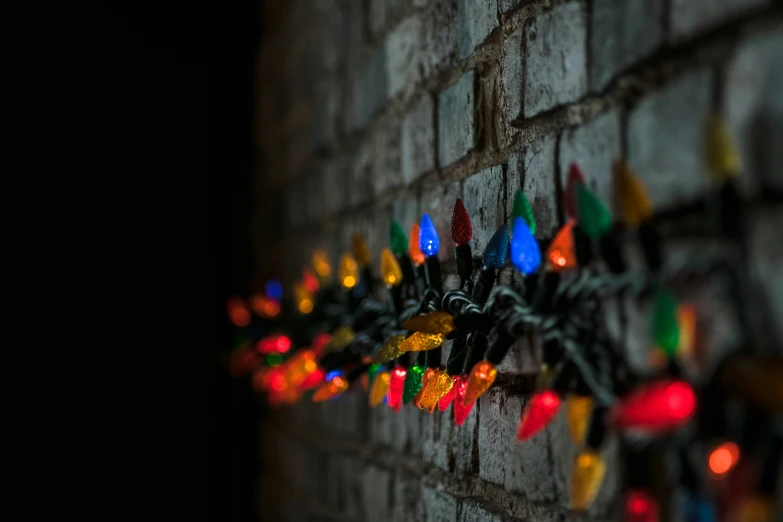 a brick wall decorated with christmas lights