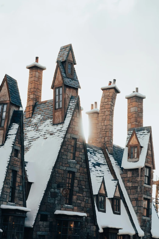 the building is surrounded by snow with two clock on each side