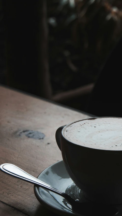 a black and white pograph of a spoon and a cup