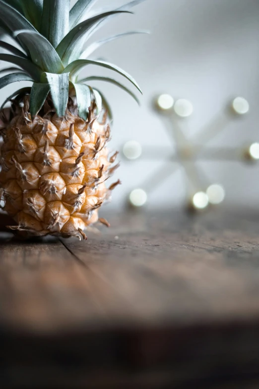 the pineapple was sitting on top of the wooden table