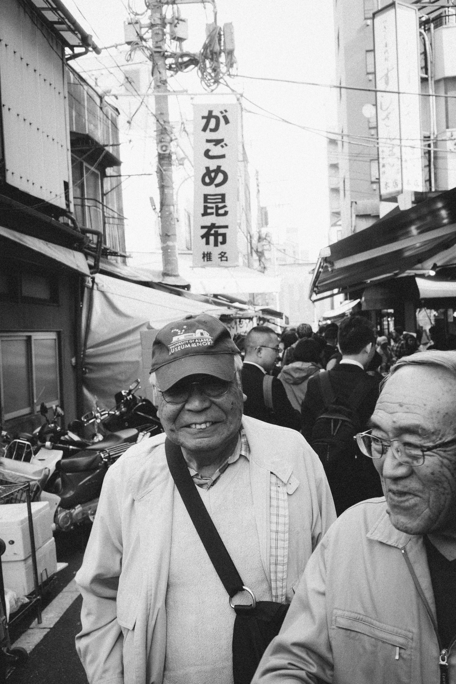 two men are walking down the crowded street