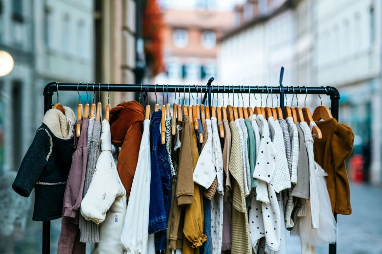 a row of folded clothes is hanging in the city